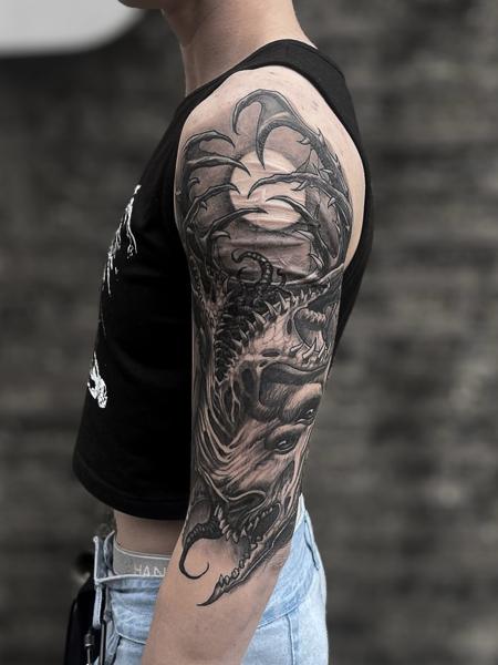 Realism dragon tattoo by @crawlspace_tattoo