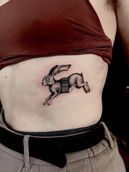 Illustrative blackwork running hare tattoo by @freakyface_