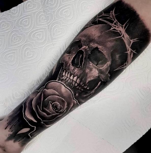 Realism skull and rose tattoo by @danny_tattooart
