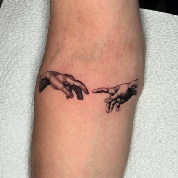 Realism hands reaching tattoo by @newidshirley