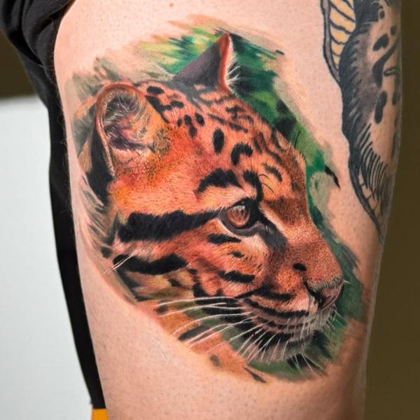Realism ocelot portrait tattoo by @daria_inkaholic