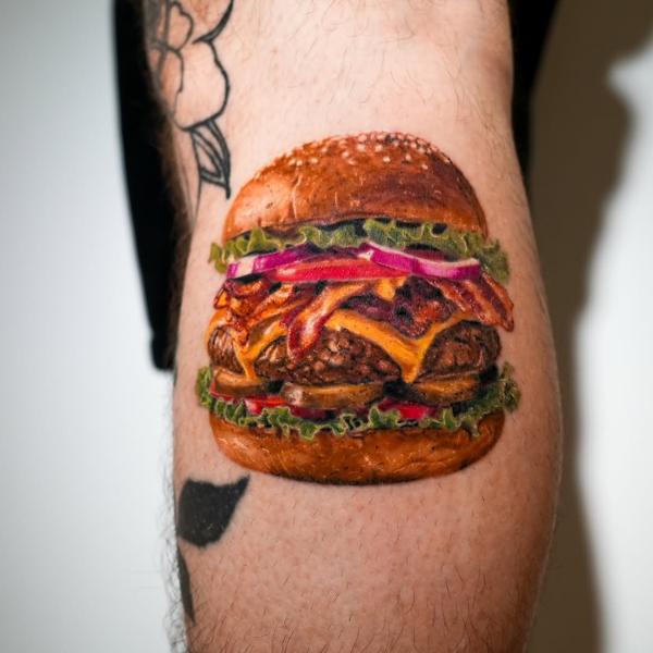 Realism bacon cheeseburger tattoo by @daria_inkaholic