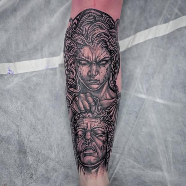 Realism medusa holding head tattoo by @truelinestattoo