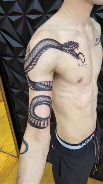 Illustrative coiled snake tattoo by @truelinestattoo