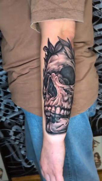 Realism laurel skull tattoo by @truelinestattoo