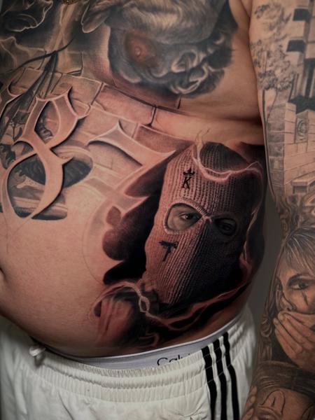 Realism masked figure tattoo by @dennisblume_tattooist