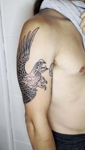 Traditional flying bird tattoo by @denotattoo