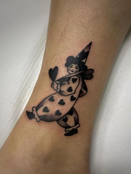 Traditional heart clown tattoo by @theblackrabbit_tattoostudio