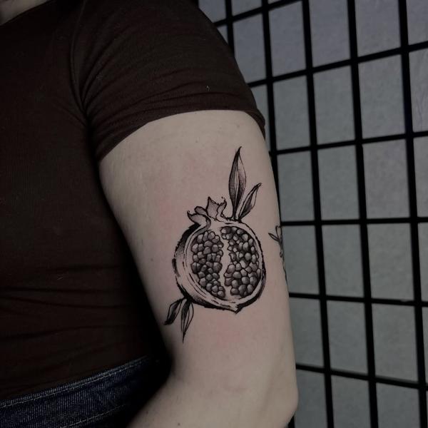 Blackwork cut pomegranate tattoo by @bdt_tattoos