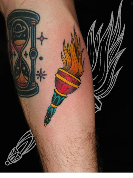 Traditional flaming torch tattoo by @fitz.ttt