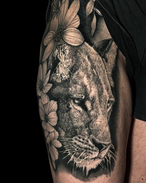 Realism lion and flowers tattoo by @doublexxtattoo