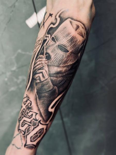 Realism masked figure tattoo by @_drag.tats