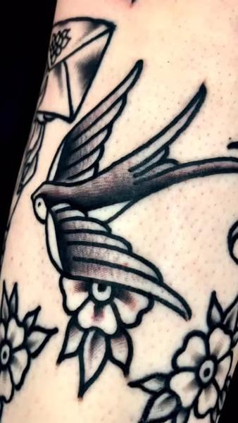 Traditional swallow bird tattoo by @edstaplestattooer