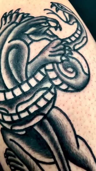 Traditional dragon snake tattoo by @edstaplestattooer