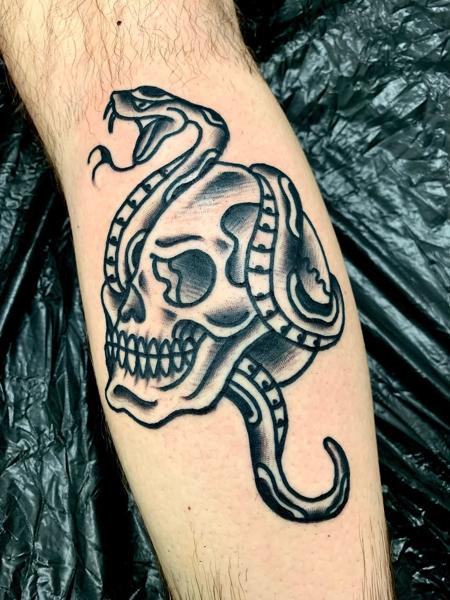 Traditional snake skull tattoo by @edstaplestattooer