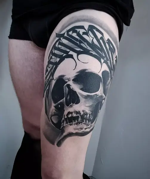 Realism skull with script tattoo by @eliotdivision