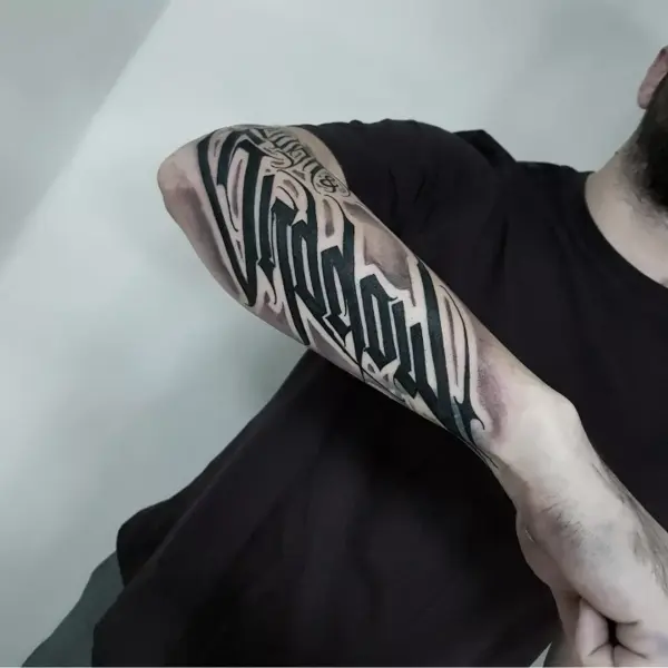 Blackwork lettering tattoo by @eliotdivision