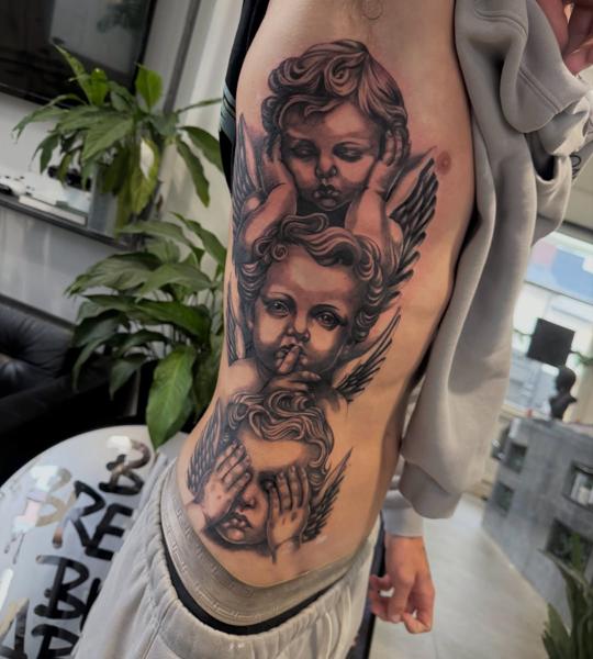 Realism cherub faces tattoo by @ellecartelle