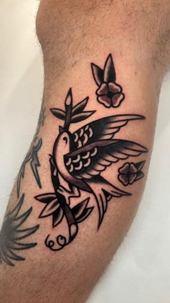 Traditional traditional swallow tattoo by @ellie_tattooer