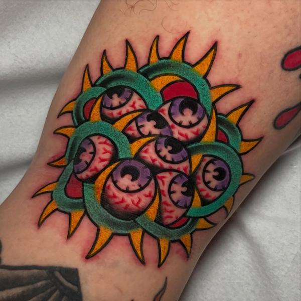 Traditional clustered eyes tattoo by @ellie_tattooer