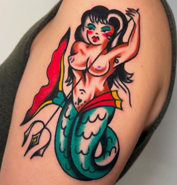 Traditional mermaid pin-up tattoo by @ellie_tattooer
