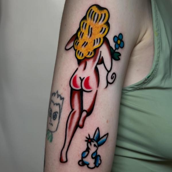 Traditional cartoon woman tattoo by @ellie_tattooer