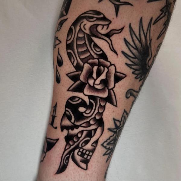 Traditional snake and rose tattoo by @ellie_tattooer