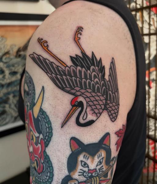 Traditional flying crane tattoo by @ewilliamstattoos