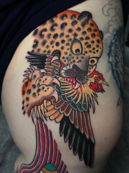 Traditional leopard and rooster tattoo by @ewilliamstattoos