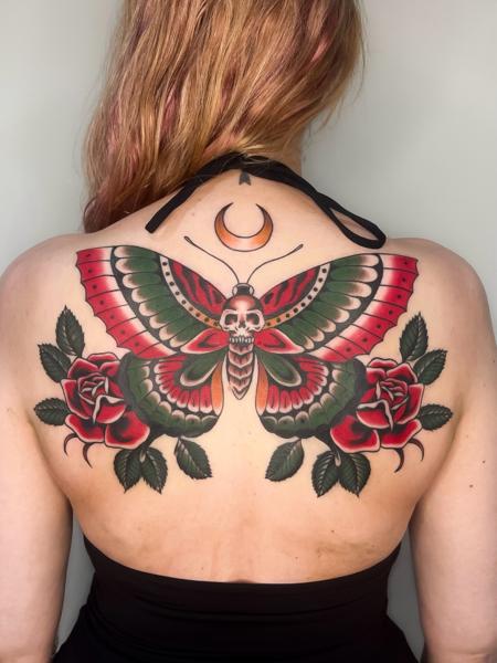 Traditional moth and roses tattoo by @emmalouisetattoo