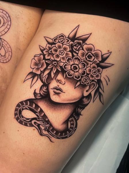 Blackwork floral snake tattoo by @emmalouisetattoo