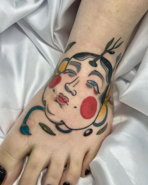 Traditional abstract face tattoo by @evanthiee