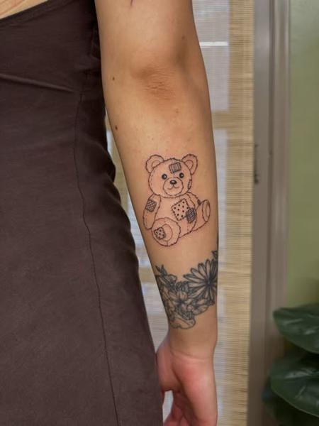 Fine line patchwork teddy bear tattoo by @moonchild_finetattoo
