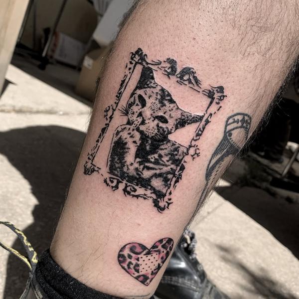 Blackwork framed cat tattoo by @xema.tattoos
