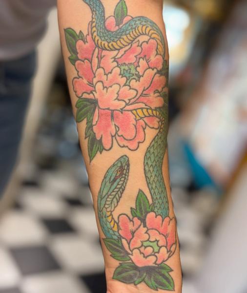 Traditional snake and flowers tattoo by @ey.ron_tattoo