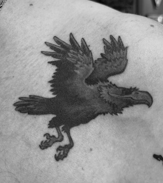 Blackwork flying raven tattoo by @ey.ron_tattoo