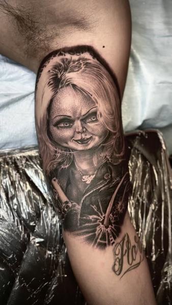 Realism horror doll tattoo by @fatboy_tattoos
