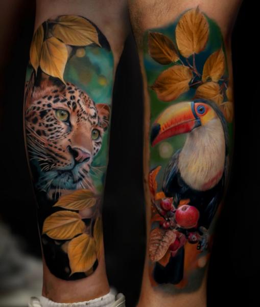 Realism leopard and toucan tattoo by @fayeskinnertattoo