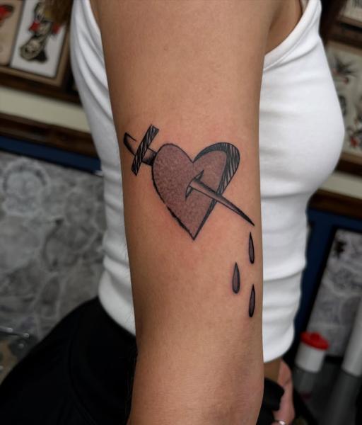 Illustrative blackwork pierced heart dagger tattoo by @billie_p_