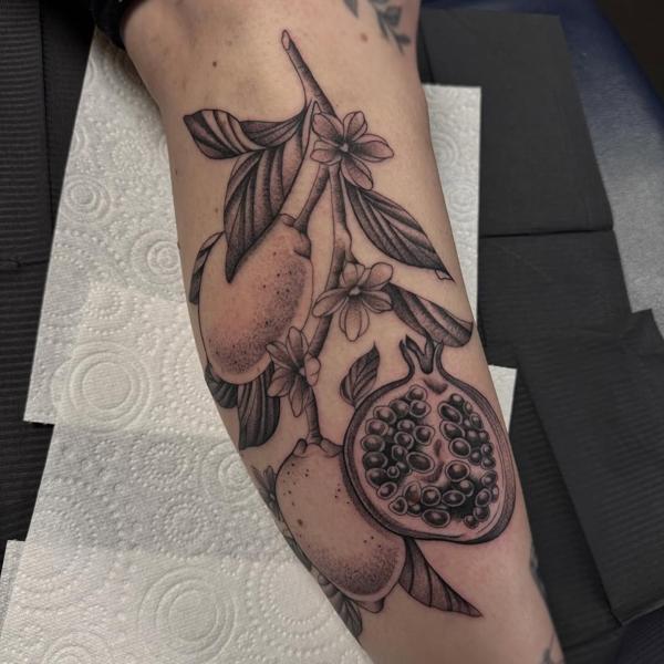 Blackwork pomegranate branch tattoo by @justbethtattoo
