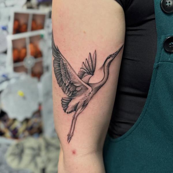 Fine line flying heron tattoo by @justbethtattoo