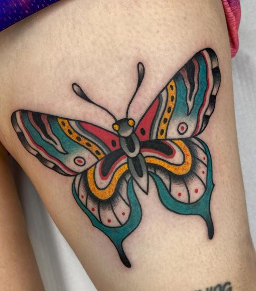 Traditional colorful butterfly tattoo by @fontascast