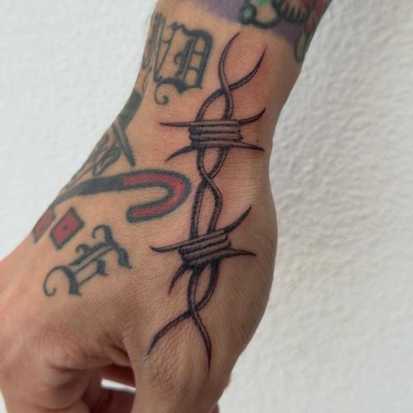 Traditional barbed wire tattoo by @void96_tattoo