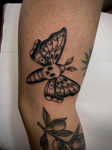 Traditional moth with skull tattoo by @frankiefasthands.ttt
