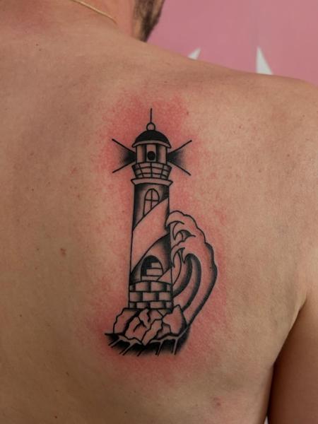Traditional lighthouse wave tattoo by @frankiefasthands.ttt