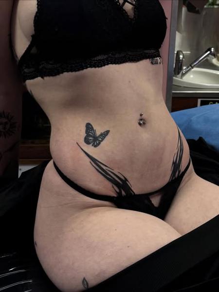 Blackwork butterfly and wings tattoo by @gayle.inklore