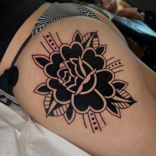 Traditional bold flower tattoo by @geeetattoos