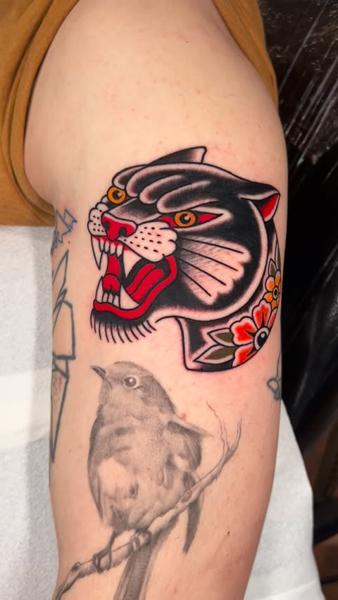 Traditional panther head tattoo by @geeetattoos