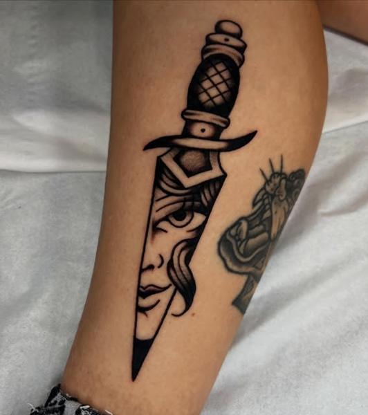 Traditional dagger face tattoo by @geeetattoos