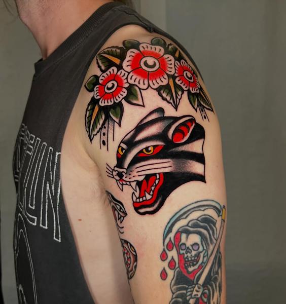 Traditional panther and flowers tattoo by @geeetattoos